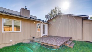 A house with a wooden deck, a satellite dish, and a clear sky. - Pet-friendly Anchorage Home - 8 Mi to Downtown! (Anchorage)