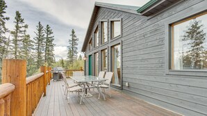 A wooden deck with a glass table and chairs, a grill, and a view of trees. - Jefferson Mountain Cabin w/ Private Deck & Grill! (Como)