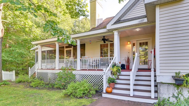 A house with a covered porch, white railings, and a staircase leading to the entrance. - Schuylerville Home: 9 Mi to Saratoga Springs! (Schuylerville)