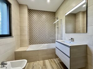 Bathtub, hair dryer, towels, soap