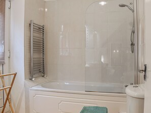 A bathroom with a glass-enclosed shower, a bathtub, and a toilet. - Welcome to Harbour Hideout, a charming property dating back to the 1800s. (Whitby)