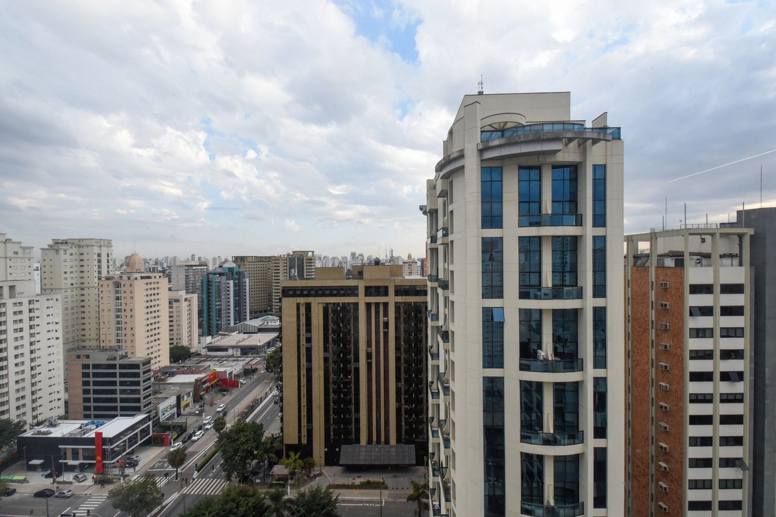 A high-rise building with multiple floors, large windows, and a modern architectural design.