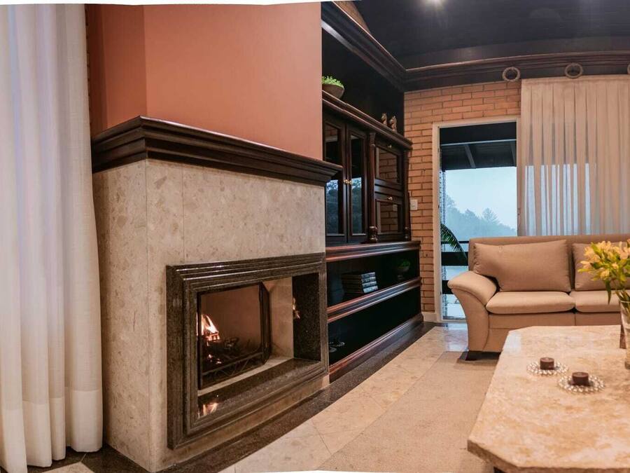 A living room with a fireplace, a sofa, and a coffee table.