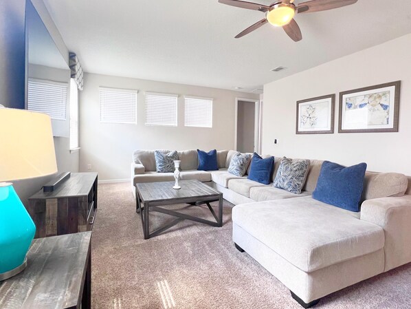 A living room with a sofa, coffee table, and a ceiling fan. - Beautiful 7Bed Pool Villa with Spa and Game Room-9007PCT (Kissimmee)