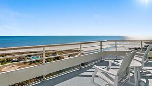 A balcony with a view of the beach and ocean. - Ocean Creek Penthouse North Myrtle Beach (Myrtle Beach)