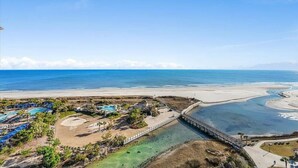 A resort with a large pool, a beach, and a bridge connecting different areas. - Ocean Creek Penthouse North Myrtle Beach (Myrtle Beach)