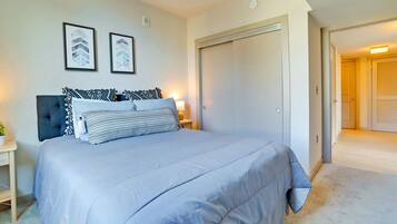 A bedroom with a bed, bedside tables, and a wardrobe.