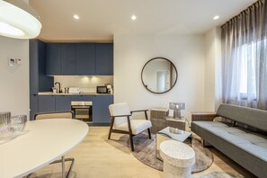 Relax in this spacious living area with a dining table, comfortable sofa, and seating area.