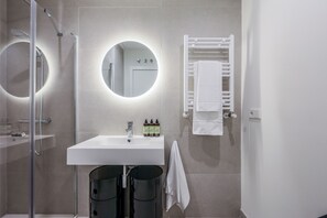 Bathroom features a sink, mirror, and towel rack.