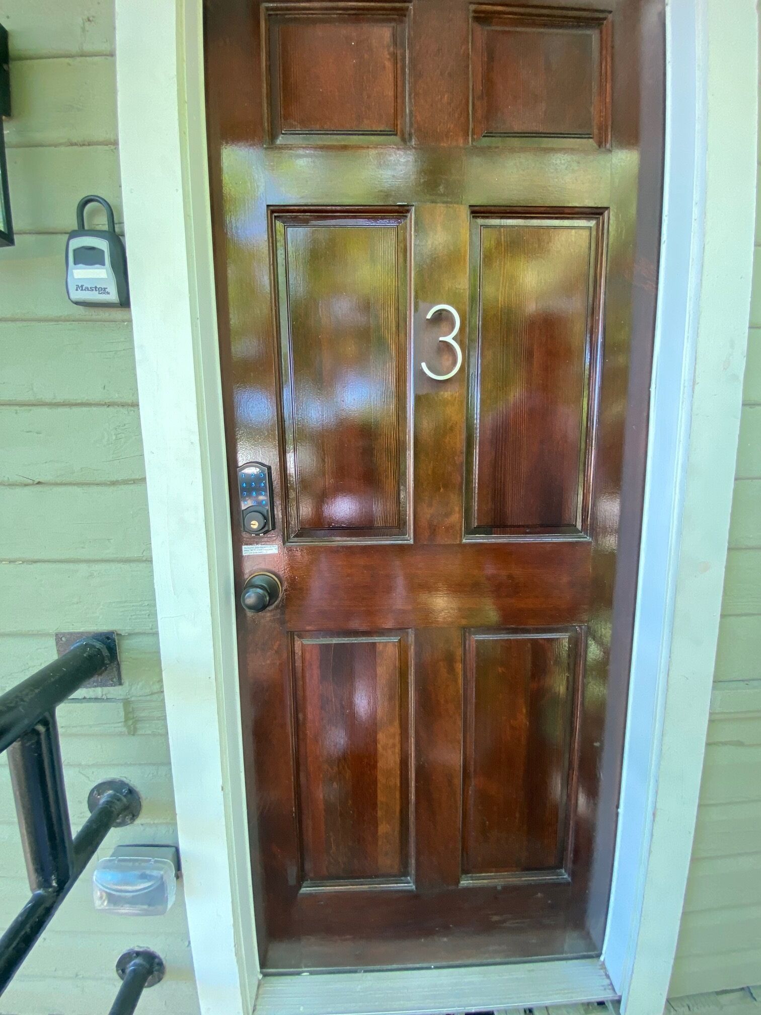 A wooden door with a number '3' and a keypad lock.
