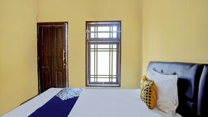 A room with a bed, a window, and a door.