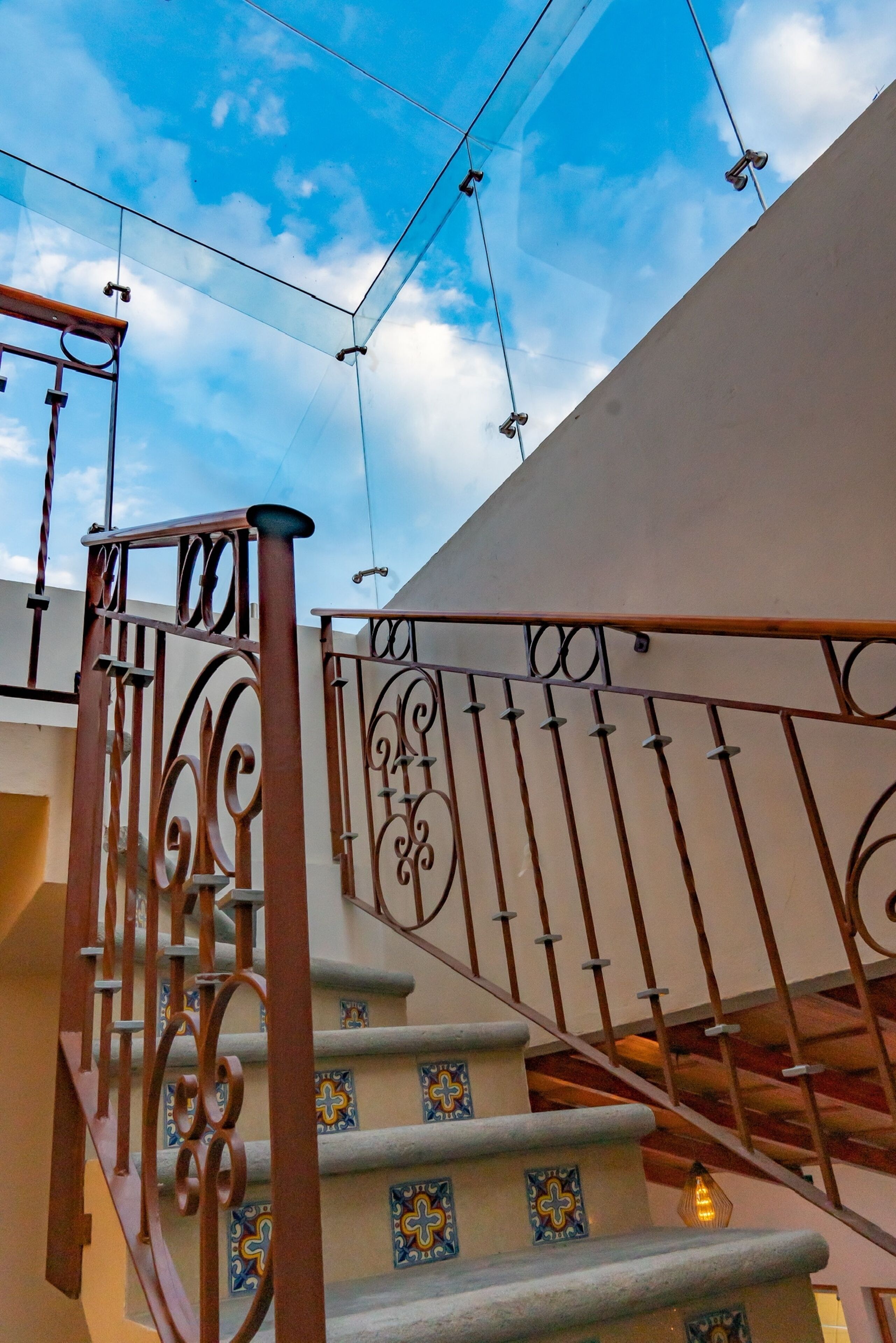 A staircase with ornate metal railings and decorative tiles.