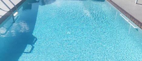 Una piscina al aire libre, una piscina climatizada