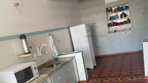 A compact kitchen with a microwave, sink, and refrigerator.