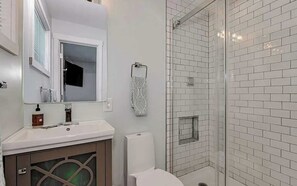 Shower, hair dryer, towels, shampoo