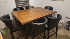 A rectangular wooden table with six black chairs. - Juana Diaz Spacious Cozy Home Mango trees and avocado. (San Juan)
