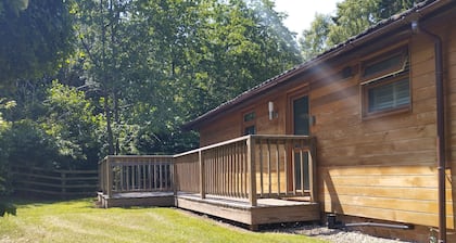 A charming & traditional Scandinavian log cabin within a tranquil setting.