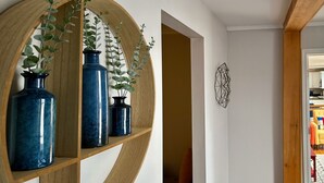 A wooden shelf with three blue vases and green plants. - Captain's suite @ The Homestead Oceanfront (Norman's Cove-Long Cove)