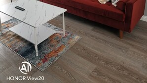 A modern living room with a red sofa, a white coffee table, and a patterned rug. - Comfortable 3 BR with parking-WS2 for contractors, professionals and families
 (Walsall)