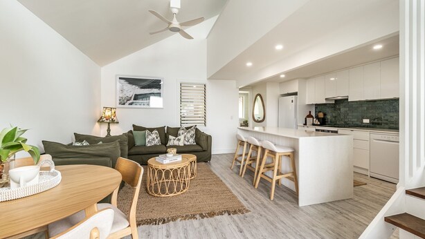 A modern apartment with a dining area, living room, and kitchen. - THE Palms Angourie - Treetop Retreat Near Spooky Beach - Holiday Yamba (Angourie)