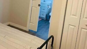 A bedroom with a bed, a door leading to a bathroom, and a small closet. - Abigael’s Apt Suite 1 BR 2 BED in Central Bridgewater

 (Bridgewater)