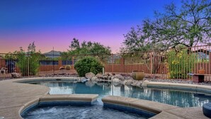 A backyard with a hot tub, a pool, and a fenced area with trees and plants. - NEW Mountain View 4 BDRM Home with Pool & Spa, right on a Golf Course (Sierra Vista)