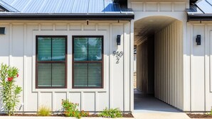 A modern house with a covered driveway and a number '950' on the wall. - *New Romantic Getaway|Hot Tub (Fredericksburg)