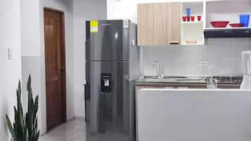 Fridge, coffee/tea maker, blender, cookware/dishes/utensils