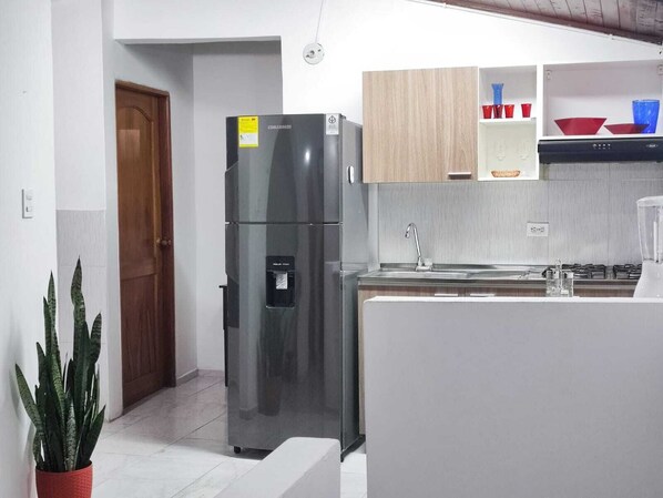 Fridge, coffee/tea maker, blender, cookware/dishes/utensils