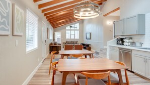 A spacious kitchen with white cabinets, a dishwasher, and a countertop with kitchen appliances. - Hot Tub & Patio: Modern Sedona Home! (Sedona)