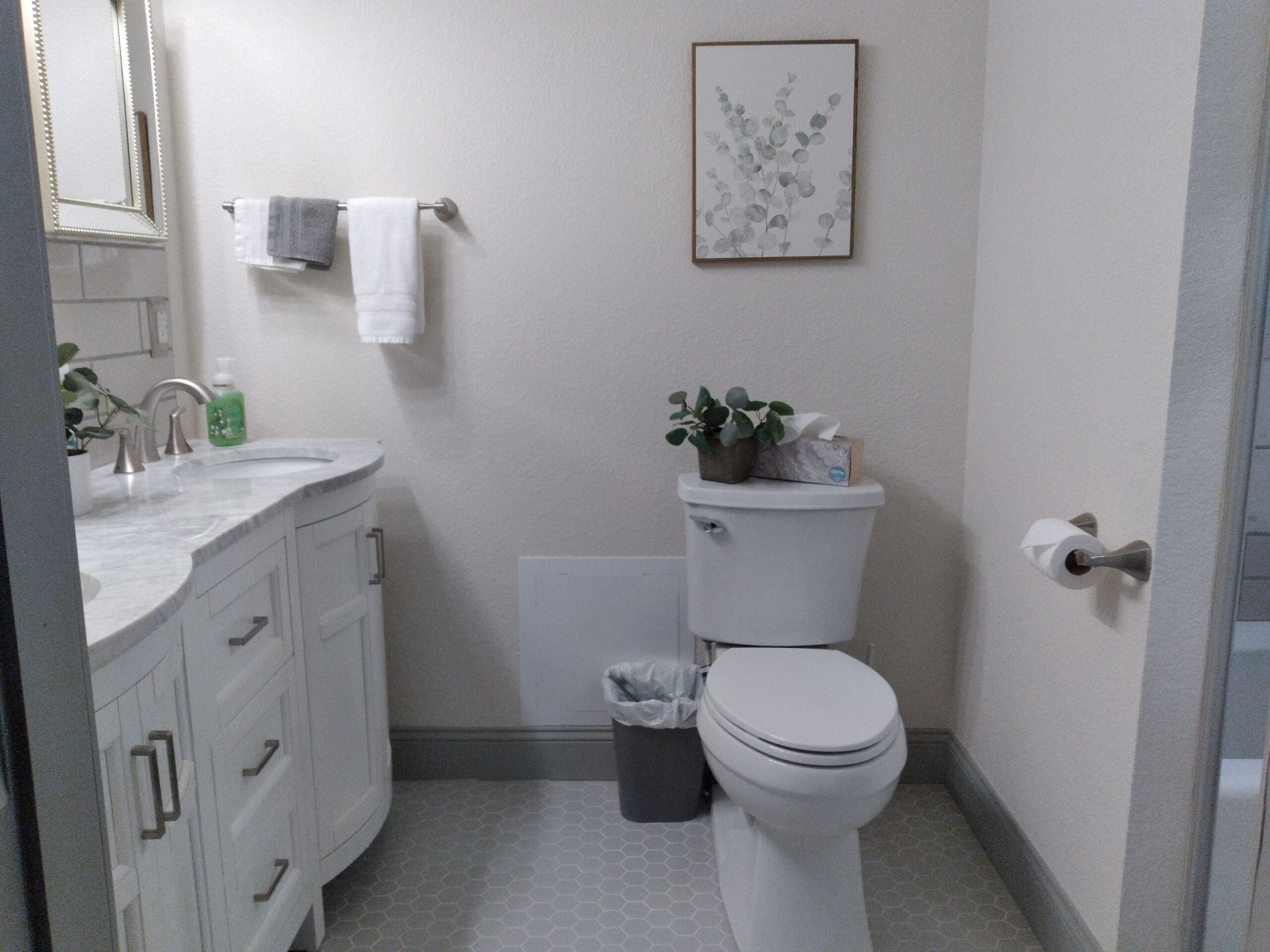 Une salle de bain avec des toilettes, un lavabo et un meuble de rangement.