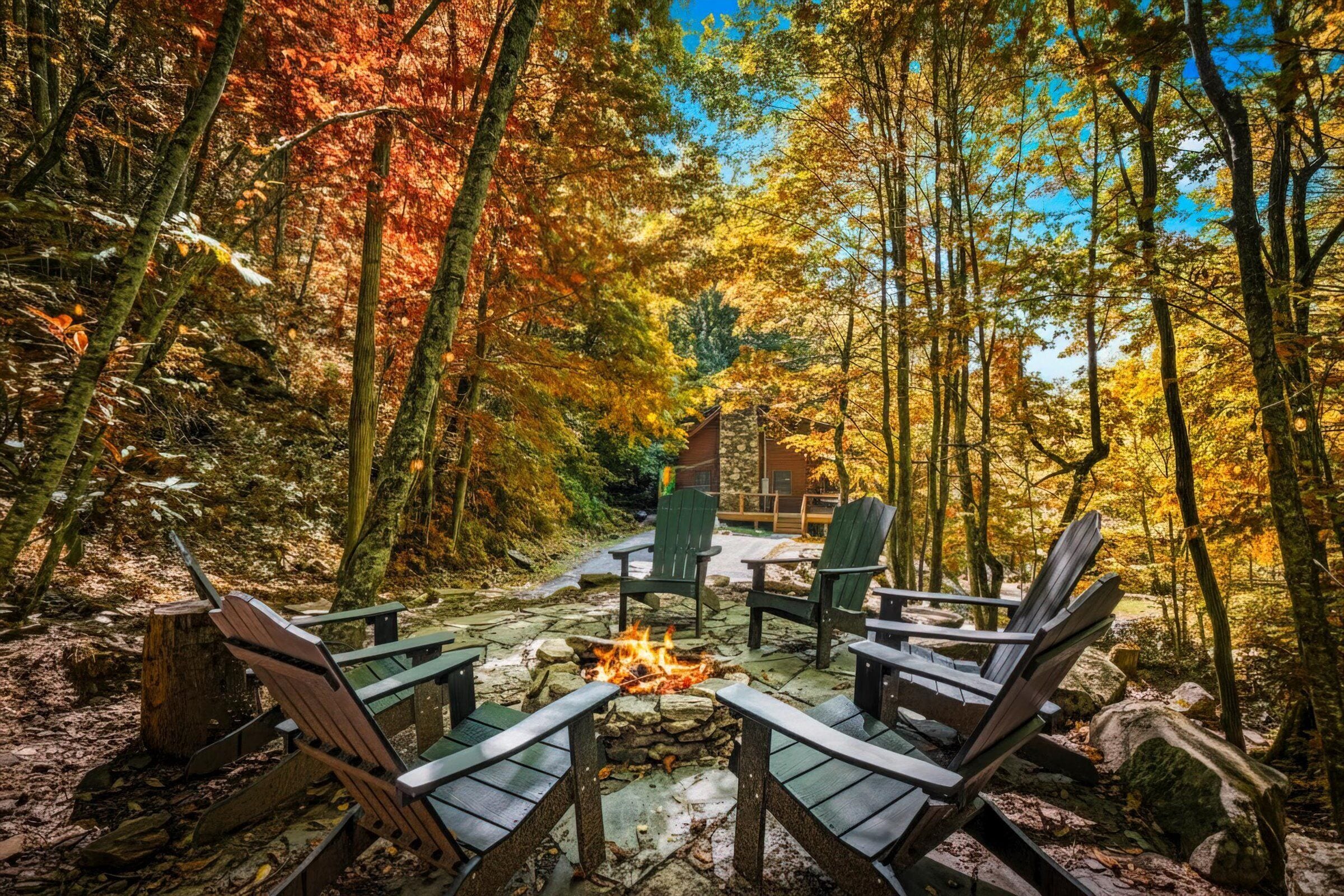 A forested area with a stone fire pit surrounded by Adirondack chairs.