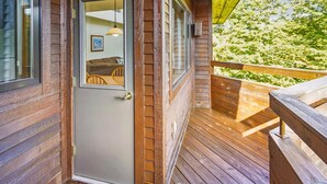 A wooden cabin with a door leading to a porch. - Welcoming Two condo with pool, hot tub, and more- J3 (Killington)