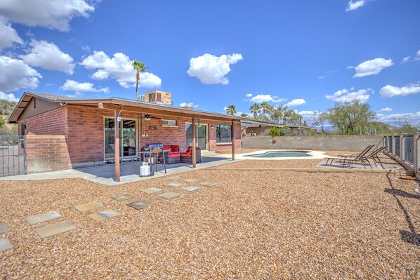 Une maison moderne dotée d’un patio, d’un espace barbecue et d’une piscine.