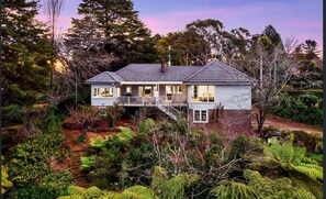 Situated in a wooded area, this house offers a secluded and tranquil environment with a spacious balcony overlooking lush greenery.