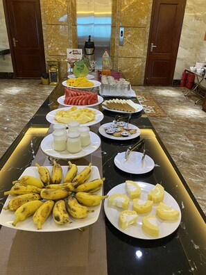A buffet with various fruits, dairy products, and bread. - Violin Bac Ninh Hotel (Vo Cuong)