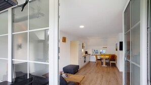 A modern, open-plan living space with a kitchen, dining area, and seating area. - Apartment 2, 65sqm, 2 bedrooms, max. 4 persons (Schmallenberg)