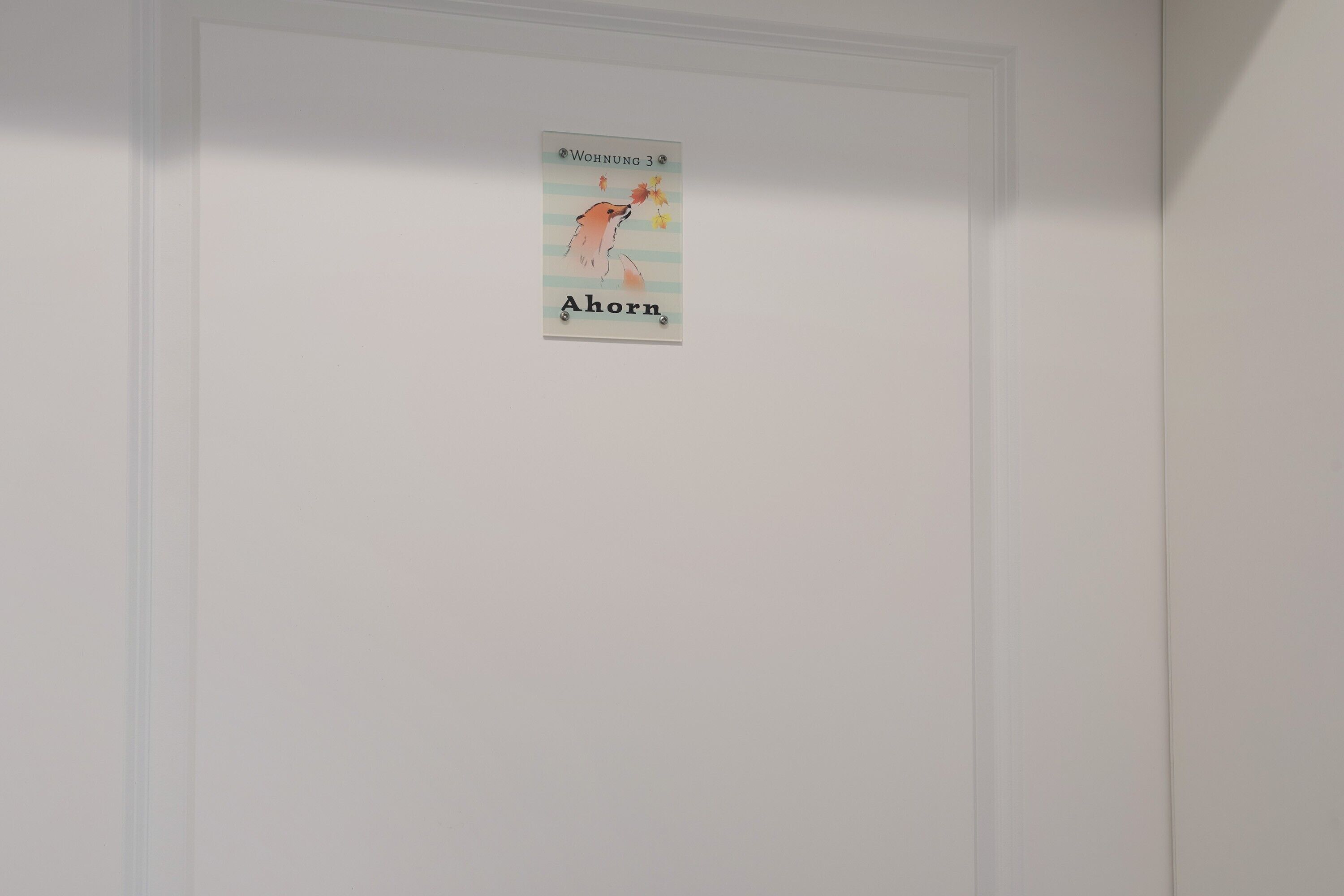 A wall with a framed poster featuring a bear and text.