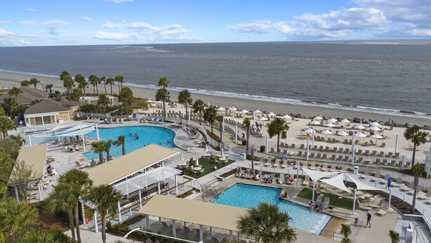 A resort with multiple swimming pools, beachside lounge areas, and a view of the ocean. - Updated Seabrook 4Bed with Golf Views, Screened Porch & Club Access! (Seabrook Island)