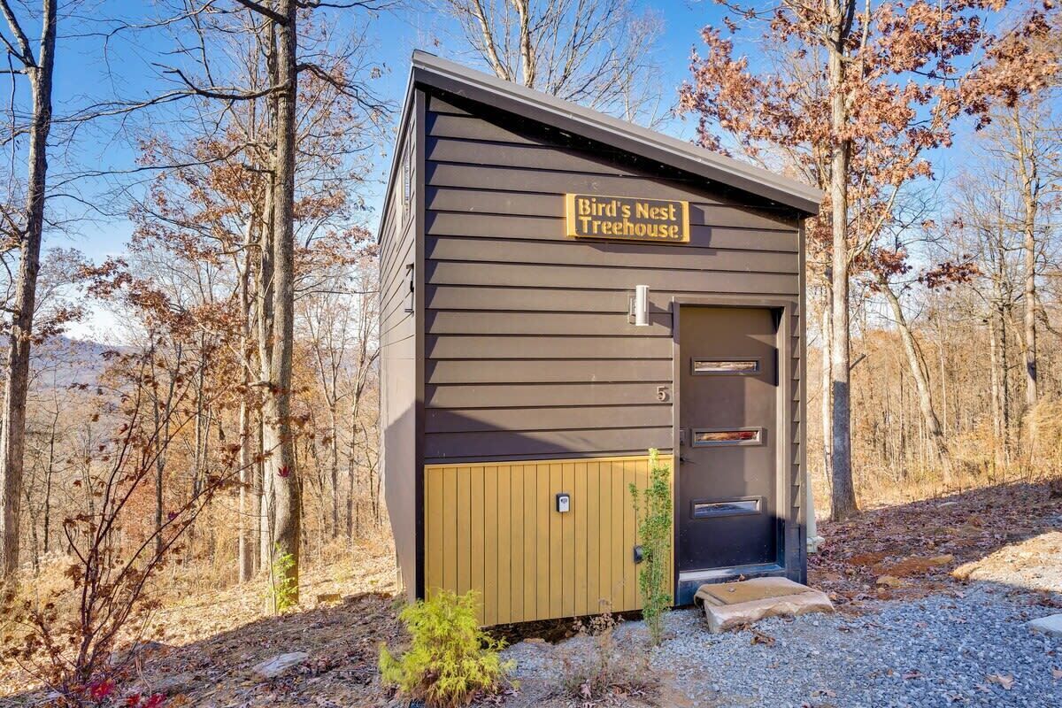 A small, single-story building with a sign reading "Bird's Nest Treehouse."