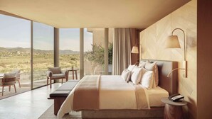 A modern bedroom with a large bed, a bedside table with a phone, and a view of the landscape through large windows. - Banyan Tree Veya Valle De Guadalupe (Valle de Guadalupe)