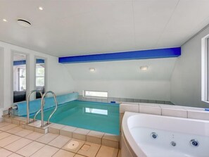 Swim and unwind in our indoor pool, featuring a modern design and convenient metal ladders.
