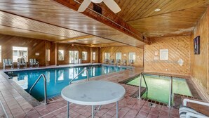 An indoor swimming pool with a ceiling fan, tiled floor, and wooden walls. - Wisconsin Dells Escape - Amazing Views - Pools (Wisconsin Dells)