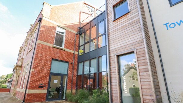 A modern building with a brick facade and large windows. - River View (Preston)