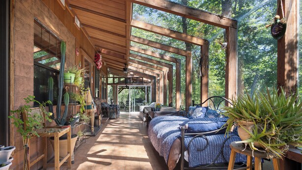 A covered patio with a bed, chairs, and potted plants. - Hot Tub Hideaway - Game Room - Near Kirkwood (West Point)