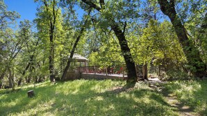 A wooded area with a gazebo and a fenced deck. - Hot Tub Hideaway - Game Room - Near Kirkwood (West Point)