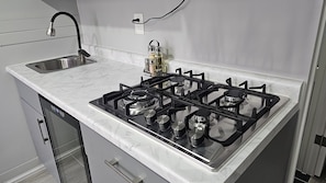 Fridge, stovetop, electric kettle, cookware/dishes/utensils