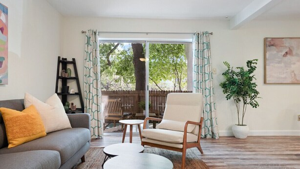 A living room with a sofa, armchair, coffee table, and a potted plant. - Hart #206 xxxxxxxxxx (Austin)