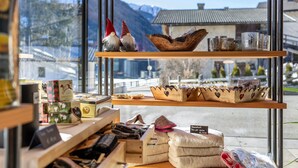 A shop with shelves displaying gnomes, wooden bowls, and various items.