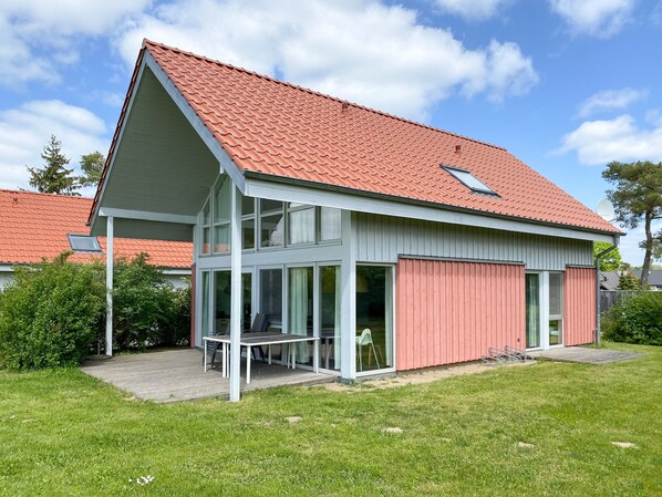 Enjoy a home away from home with a covered patio and sliding glass door leading to a spacious interior.